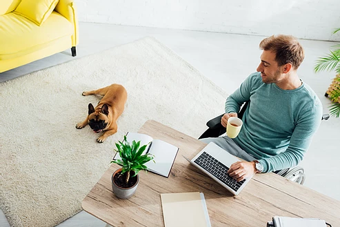man working from home with dog